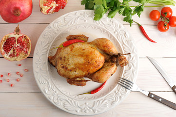 whole roasted chicken with bound feet in a bowl of hot chilli pe