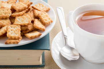 White plate with crackers on an old book