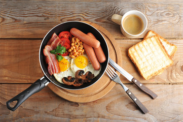fried eggs with bacon, tomatoes, beans, mushrooms and sausages i