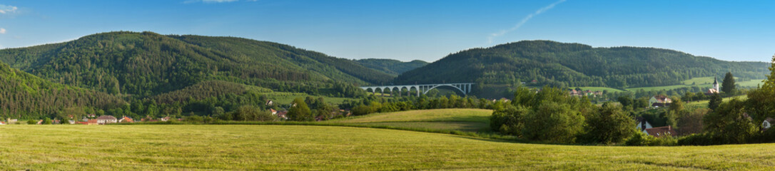 Fototapeta na wymiar Large panorama landscape with hills. Meadows near the village of Dolni Loucky in Czech Republic. Look to your landscape with the railway bridge. 