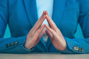 Steepled fingers of business woman as hand gesture confident sig
