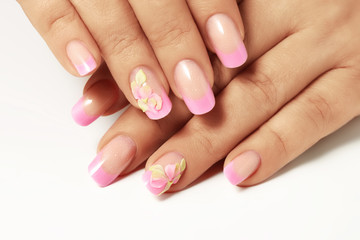 Female hands with New Year design on the nails holding snowflake.Isolated.