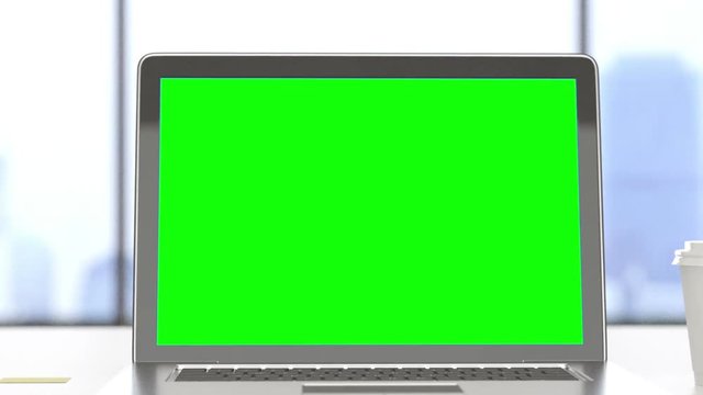 Laptop with track green screen on a desktop