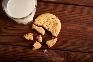 Cookies and milk. Chocolate chip cookies and a glass of milk. Vintage look. Tasty cookies and glass of milk on rustic wooden background. Food, junk-food, culinary, baking and eating concept