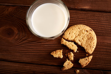 Cookies and milk. Chocolate chip cookies and a glass of milk. Vintage look. Tasty cookies and glass of milk on rustic wooden background. Food, junk-food, culinary, baking and eating concept