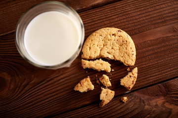 Cookies and milk. Chocolate chip cookies and a glass of milk. Vintage look. Tasty cookies and glass of milk on rustic wooden background. Food, junk-food, culinary, baking and eating concept