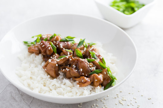 teriyaki chicken with rice in white bowl