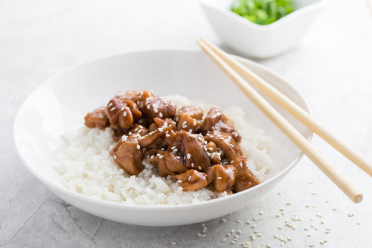 teriyaki chicken with rice in white bowl