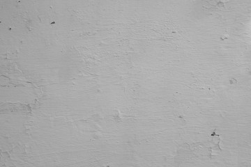 Grunge background with peeling paint. Old wall background. cracked color caused by moisture. Close up of peeling painted Cracking plaster on paint the old white wall