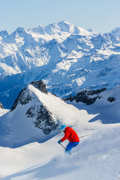 Skier skiing downhill Valle Blanche in french Alps in fresh powd