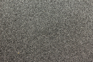 Grainy, noisy black and white sprayed paper pattern background.