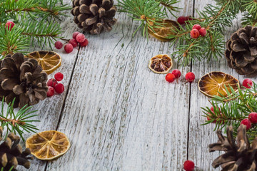 Christmas branches with cones viburnum berries and dry lemon slice