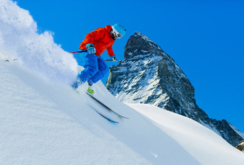 Man skiing on fresh powder snow with Matt