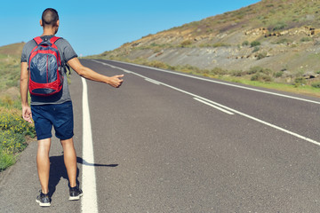 young man hitchhiking