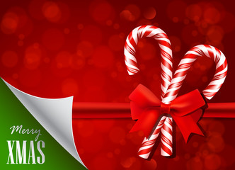 Christmas background with candy cane and red bow.
