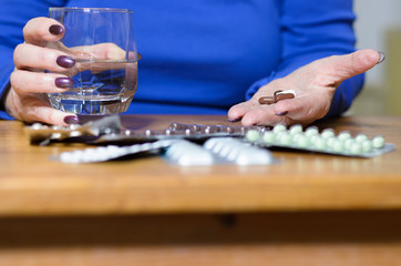 Elderly woman with an array of medication