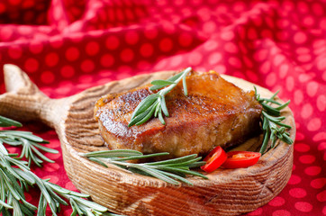Grilled meat with rosemary on a kitchen Board