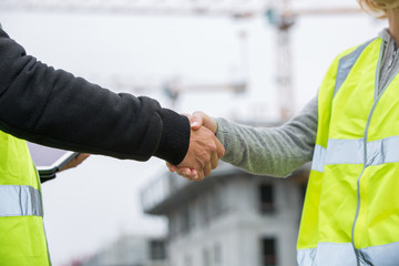 Construction workers shaking hand