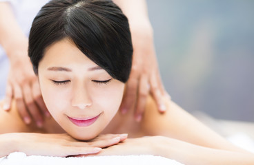 young woman in spa salon getting massage