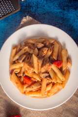 Penne pasta with mushrooms, chicken, tomatoes and cheese parmesa