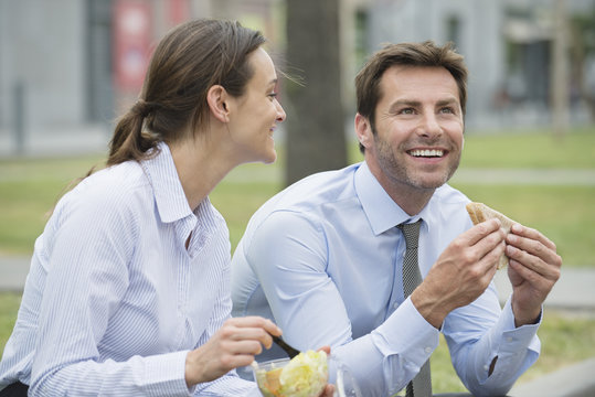 Coworkers having lunch together outdoors