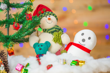 Snowman and gift boxes on bokeh background