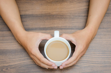 Man hands holding coffee cup in heart shape