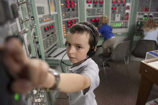 Boy enjoying interactive exhibit at space museum