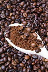 instant coffee in spoon on coffee beans background