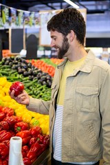 Man buying vegetables in organic shop