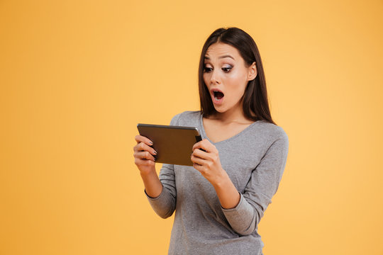 Young surprised model with tablet