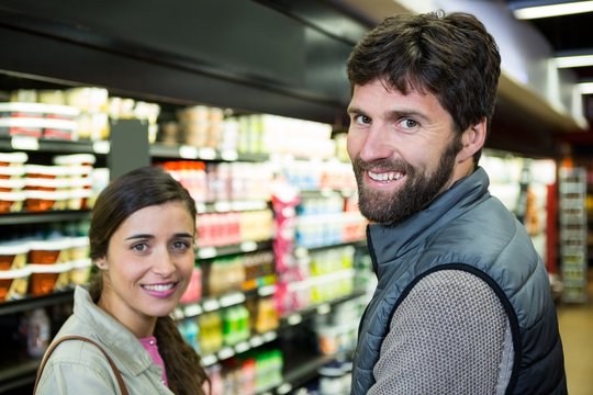 Portrait smiling couple in grocery section