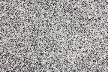 Black spray stains on white paper background.