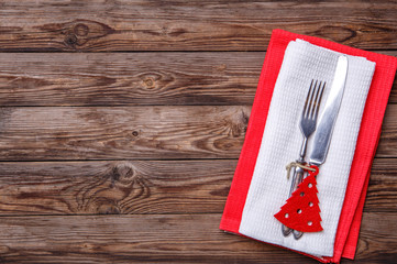 Christmas table place setting with fork and knife, decorated christmas toy - red fir-tree.