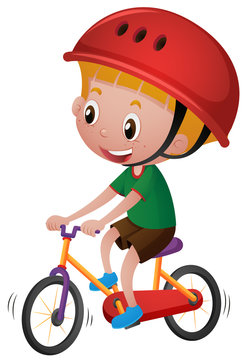 Boy riding bicycle with his helmet on