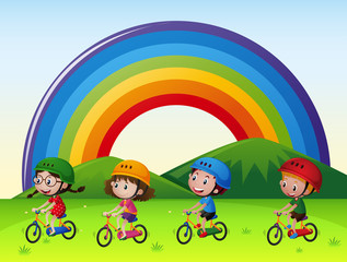 Fototapeta na wymiar Four kids riding bike in the park