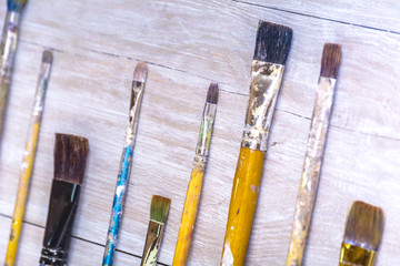 Obraz premium Artistic paintbrushes on artist canvas covered with oil paints