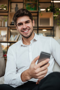 Businessman sitting in cafe and chatting by phone