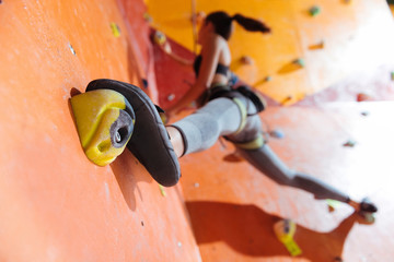 Flexible woman training hard in climbing gym
