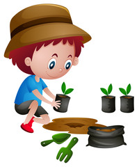 Boy planting trees in the ground