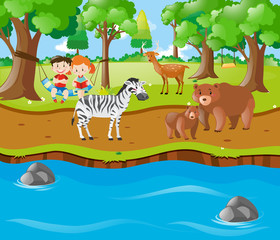 Obraz na płótnie Canvas Children and animals by the river