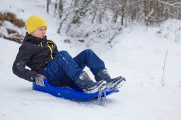 Fototapeta na wymiar kids have fun sledding with snow slides