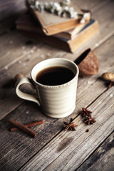 Large Cup of coffee on vintage wooden background. Spring flowers and books.