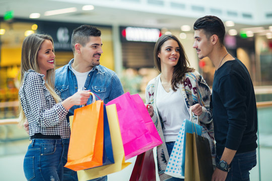 Group Of Young Friends Shopping In Mall Together