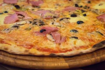 italian pizza on a wooden cutting board