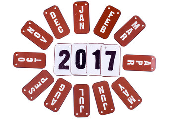 2017 year symbols and red month tiles around the date. Isolated on a white background