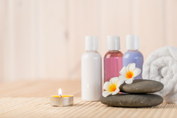 Obraz na płótnie Canvas burning candle and beauty products for massage and spa treatment