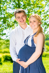 Fototapeta premium Happy family waiting for replenishment, a walk on summer park