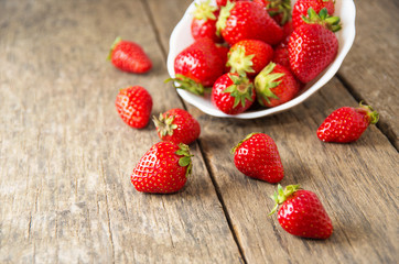 Ripe red strawberries on wooden table