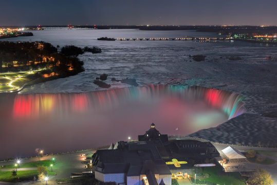 Aerial view of colorful lights on Horseshoe Falls at night, Niagara Falls, Canada.